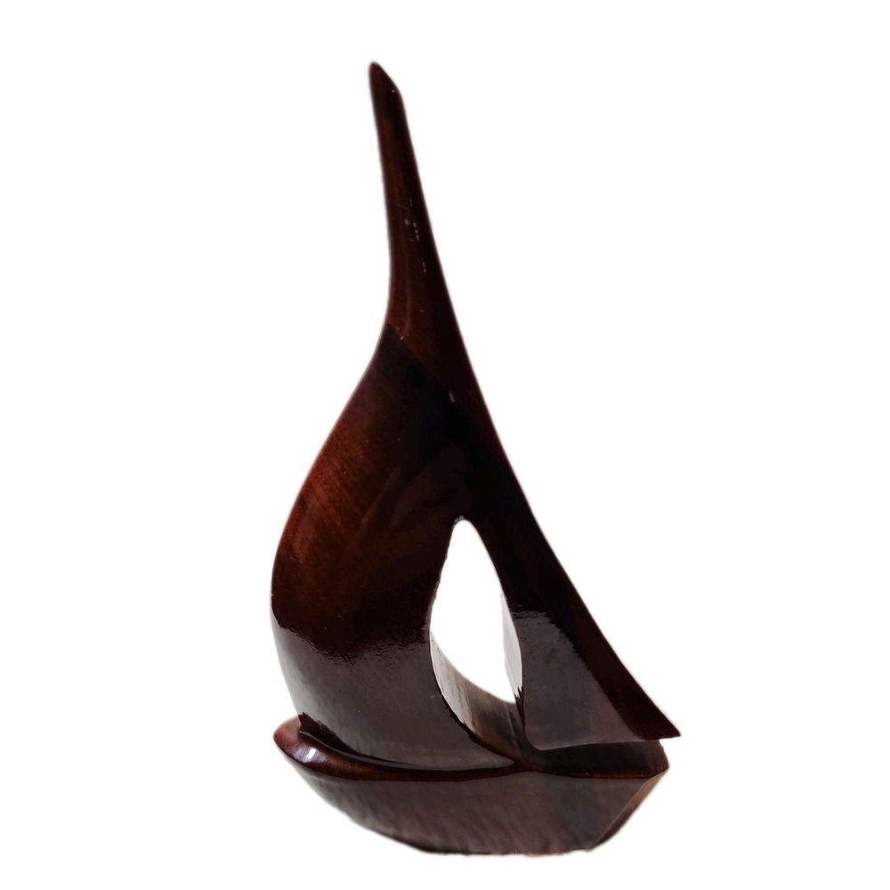 Medford Mahogany Creations hand-carved mahogany wooden sailboat figurine.